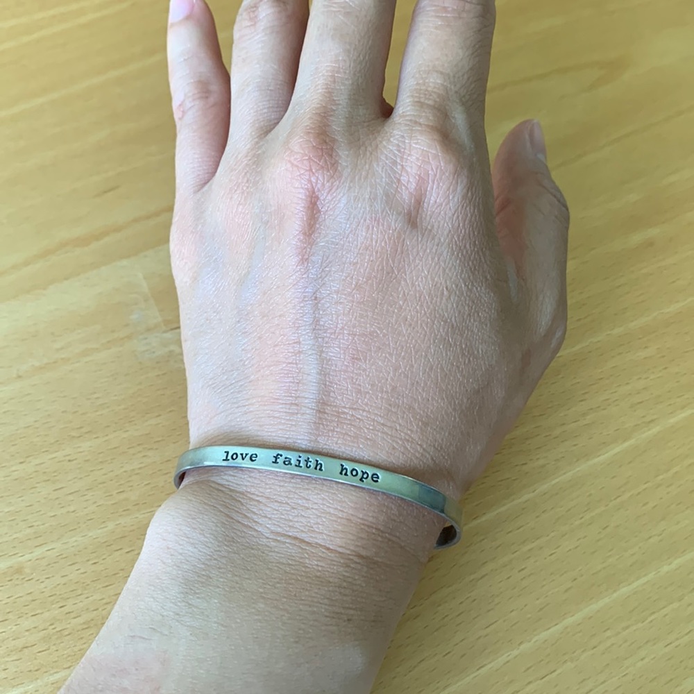 Silver bracelet “Love Faith Hope.”